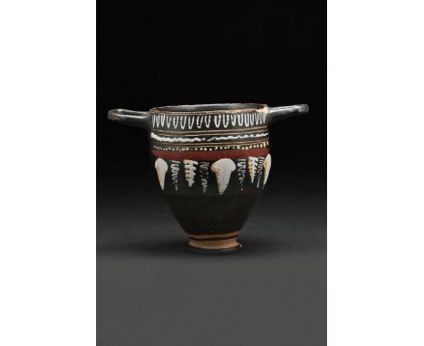 Southern Italian, Ca. 375-300 BC An elegant Gnathian-style skyphos featuring a rounded body on a ring base and ear-shaped hor