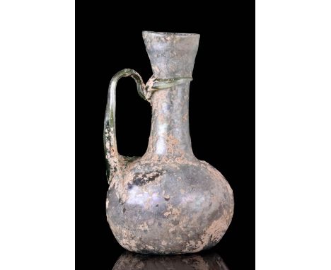 Ca. 200-300 AD A beautiful jug featuring an ovoidal body, flaring, funnel-shaped neck and a high-arching handle connecting th