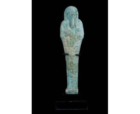 Late Period, 30th Dynasty, Ca. 332 BC A vibrantly coloured shabti in stylised mummiform pose, moulded in a light-blue, glazed