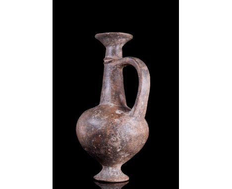 Ca. 1400-1200 BC A fine globular flask in a burnished reddish brown fabric standing on a ring base with tapering neck and fla