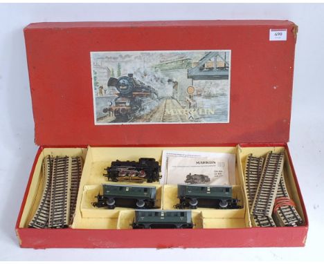 A Marklin c1960s ref. CM 827/3 train set containing 0-6-0 DB tank engine, 3 green four wheel coaches, track oval, box missing
