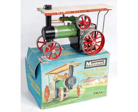 A Mamod TE1A traction engine, comprising green, red and white body, sold in the original all-card box with steering rod and f