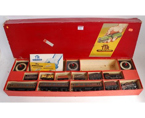 A Trix Twin Railway long red set box containing freelance LMS red 0-4-0 engine and tender No. 5670 (FG), 3 shorter bogie coac