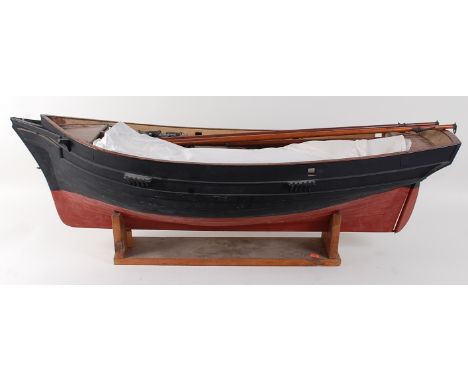 A vintage clinker built large scale model of an Admiralty Cutter type boat, with varnished deck, painted hull, various masts 