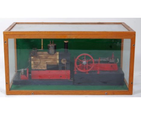 Horizontal mill engine in sealed glass display case. Steel engine on wood plinth with single fixed cylinder approx 1'' bore, 