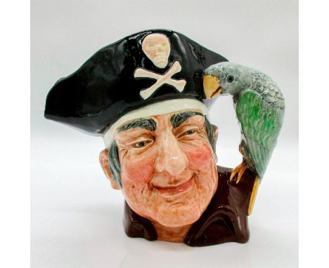 Glazed, hand painted ceramic. The pirate is in a maroon shirt, and black and white pirate hat. The handle is a green and grey