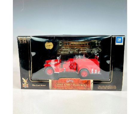 A factory sealed authentic replica of a Gmc Fire truck made from die cast metal with plastic parts, opening hood, coiled hose