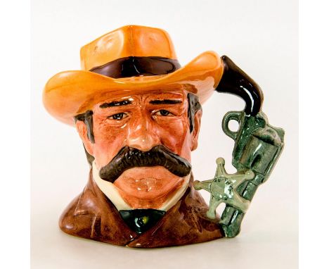 Brown coat; light brown hat with red band.Royal Doulton backstamp, The Wild West Collection Artist: Stanley J. TaylorIssued: 