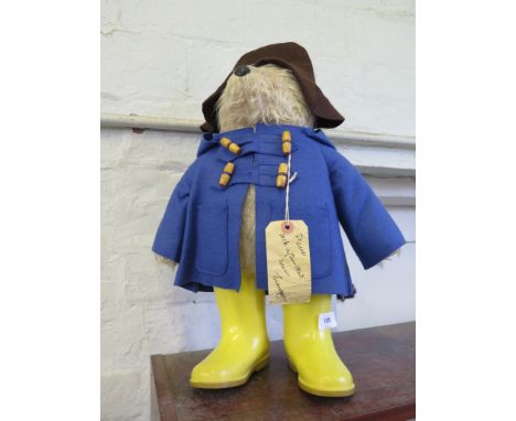 A Gabrielle Designs Paddington Bear, with brown hat, blue coat and yellow wellies, 53 cm high 