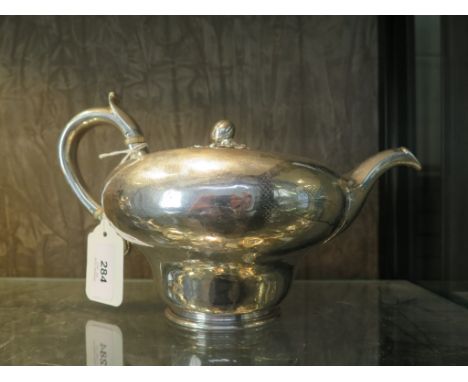 A William IV silver inverted baluster teapot, with worn engraved decoration, London May/June 1837, maker's mark I.T., 15 cm h