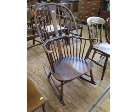 An Ercol stained beech and elm Windsor type rocking chair, with blue and gold label 