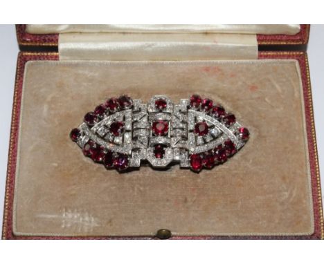 A diamond and ruby double clip circa 1940, breaking down to two clips and a brooch 