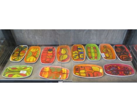 Twelve Poole Pottery Delphis rounded rectangular dishes, 18 cm wide, ten with painters marks, some as found 