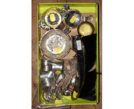 A miscellaneous collection of silver to include eight napkin rings, cream jug, two tea strainers (one with base), brush, todd