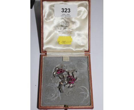 A diamond and ruby two headed flower brooch in fitted Carringtons of 130 Regent Street, London box 