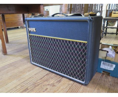 A Vox AC30 amplifier, serial no. 7407D1020, with foot pedal, cover and later carrying handles 