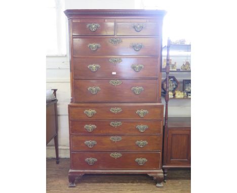A George III mahogany chest on chest, the dentil cornice over two short and three long drawers flanked by inlaid canted corne