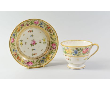 A RARE NANTGARW PORCELAIN BREAKFAST CUP & SAUCER having a dentil gilt rim and a continuous chain of flowers and roses to a gi