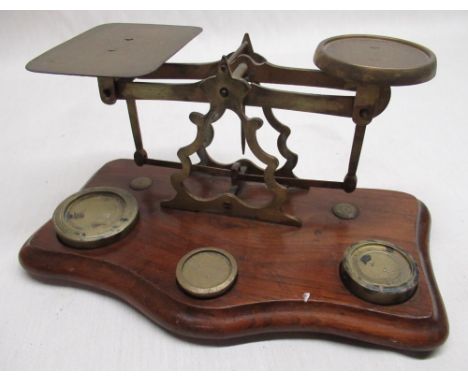 Early C20th brass postage scales pierced and shaped centre on shaped and molded mahogany base W23cm D13cm H12cm together with