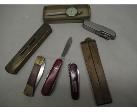 Victorinox Swiss army knife, wooden folding rule, wood and brass spirit level, map measurer and three other pen knives (7) 