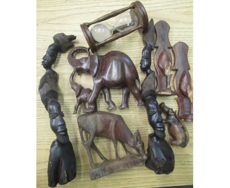 Selection of wooden items including carved African heads, elephants, hippopotamus, oak egg timer, etc 