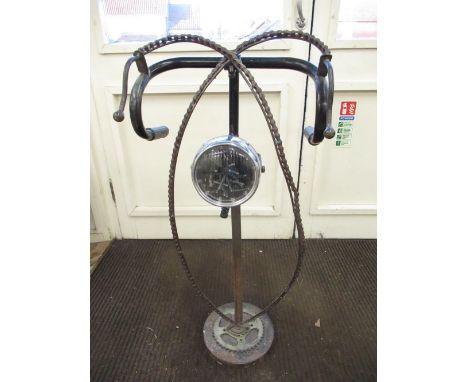 Diesel Punk transport inspired floor lamp, with motorcycle lamp on column support with drop handlebar and bike chain detail o