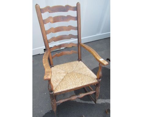 Elm ladder back rush seated rocking armchair with forge made metal rockers 