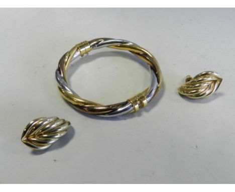 A pair of yellow metal scroll earrings, the backs stamped 585, together with a yellow, white and rose metal hinged bangle sta