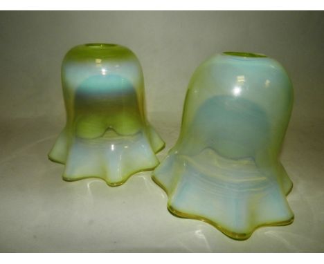 A pair of vaseline glass lighting shades