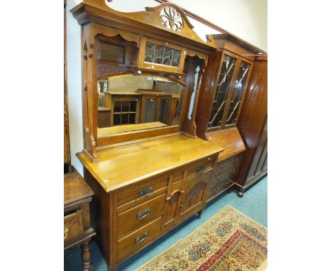 Art Nouveau walnut mirror back sideboard with pierced cornice above a leaded light drop-down door over a mirror and two friez