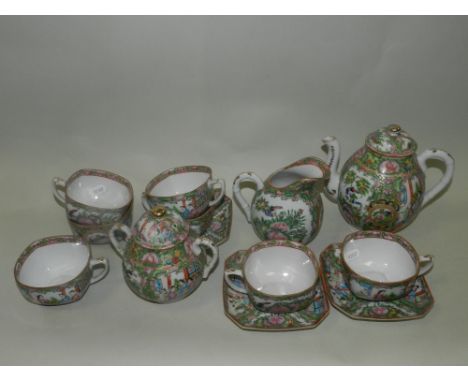 A Chinese Canton enamel tea service comprising tea cups, sucrier and cover, saucers, side plates, tea pot and cover, cream ju