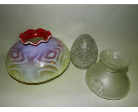 An early 20th century vaseline glass lamp shade of onion form with crimped top decorated with stylised flowers together with 