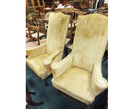A pair of William and Mary style enclosed armchairs with high panel backs and lemon yellow covers on bobbin turned and block 