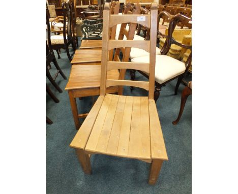 A set of four beech slat seat tapering ladder back chairs