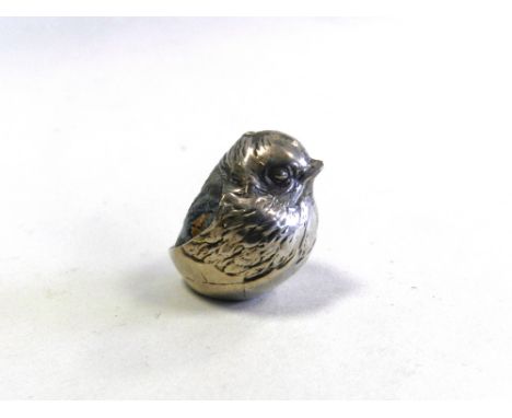 A silver mounted pin cushion in the form of a chick hallmarked Chester