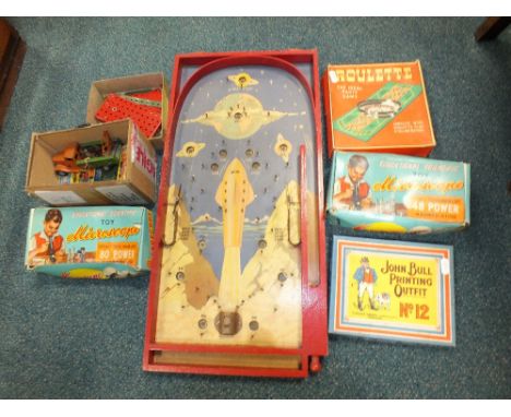 A group of toys to include two microscopes, a printing outfit and roulette set together with a 1950s bagatelle with attractiv