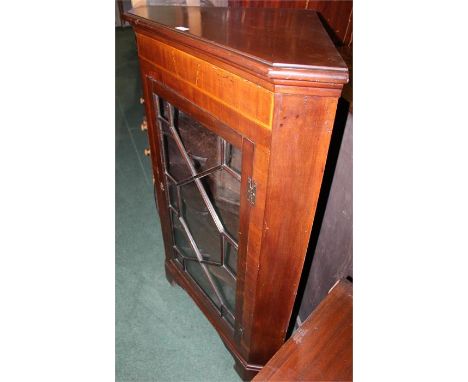 Edwardian mahogany and marquetry inlaid standing corner cupboard, the astragal glazed door opening to reveal three shaped fro