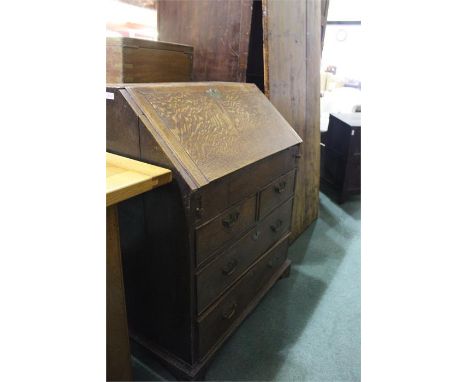 18th century oak bureau, the fall flap opening to reveal a fitted interior with central cupboard, pigeon holes and small draw