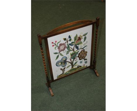 Needlework firescreen, flanked by barley twist columns, 56cm wide