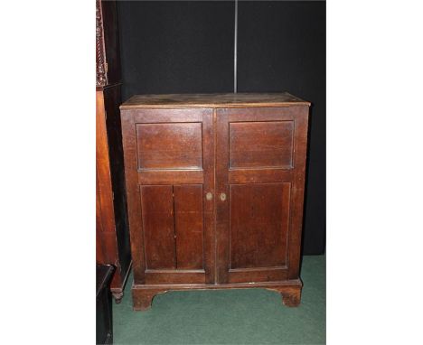 20th century oak cupboard with two panelled cupboard doors opening to reveal three interior sliding trays, on bracket feet, 9