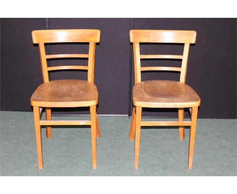 Two light wood dining chairs, with turned cresting rails, solid seats, on square tapering legs