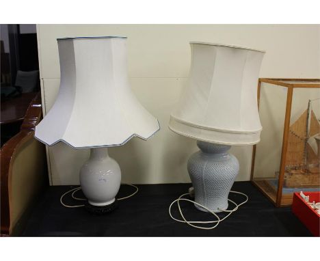 Two ceramic table lamps, one white, one blue, with shades, together with a yellow metal table lamp with shade, a white metal 