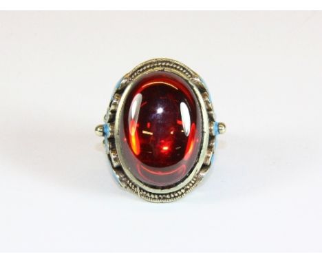 A gents Chinese enamelled ring set with a large polished "ruby stone" / realgar ((S)adjustable)