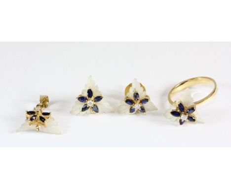 A yellow metal (tested 18ct gold) suite of jewellery comprising of ring, pendant and earrings set with carved mother of pearl