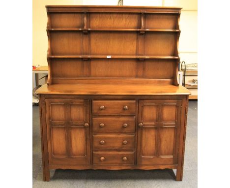 An Ercol oak dresser, W 145cm
