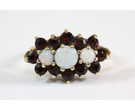 A 9ct gold garnet and opal cluster ring (L)