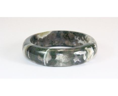 A grey, white and green spinach jade bangle (internal Dia 5.6cm)