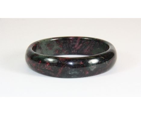 A mixed colour jade / hardstone bangle (internal Dia 5.8cm)