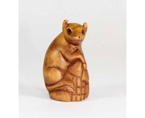 A signed fruitwood netsuke of a pig with black onyx eyes