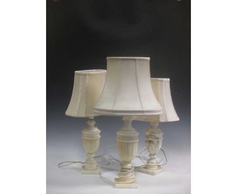 A Continental 'rococo' porcelain group of a boy and girl playing an oboe; and three white marble or alabaster lamp bases
